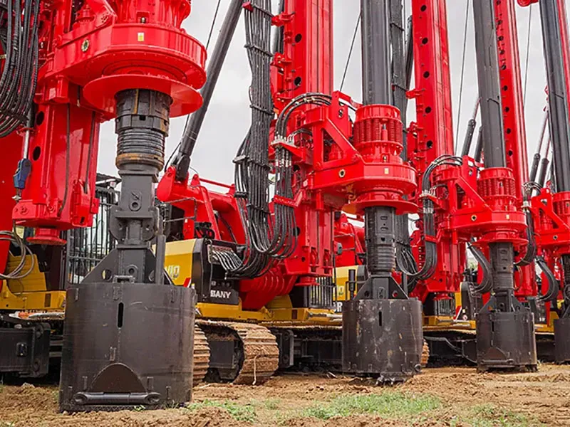 Wide shot of multiple SANY rigs working simultaneously on the large site